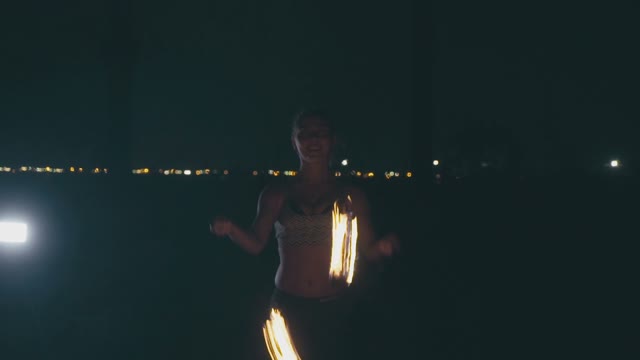 Enchanting Blond Woman In A Fire Show At Night