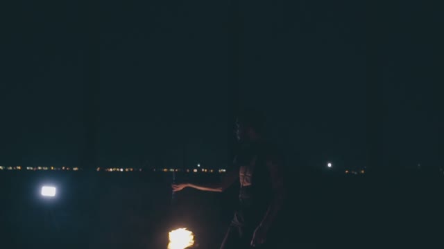 Attractive Muscular Guy Breathes Fire At Night
