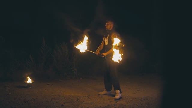 Young Muscular Guy In A Fire Show At Night