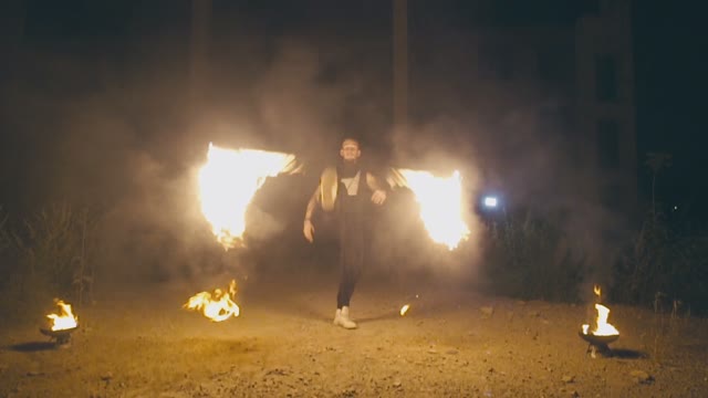 Daring Muscular Guy In A Fire Show At Night