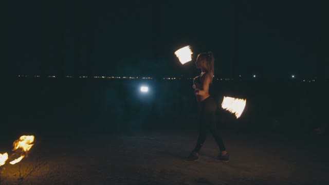 Charming Blond Woman In A Fire Show At Night