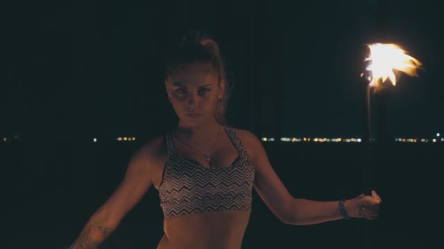 Charming Blond Woman In A Fire Show At Night
