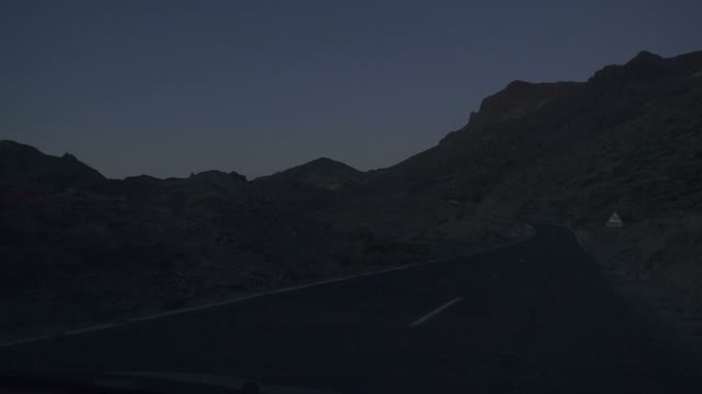 Car On The Road Moving Close To The Mountains