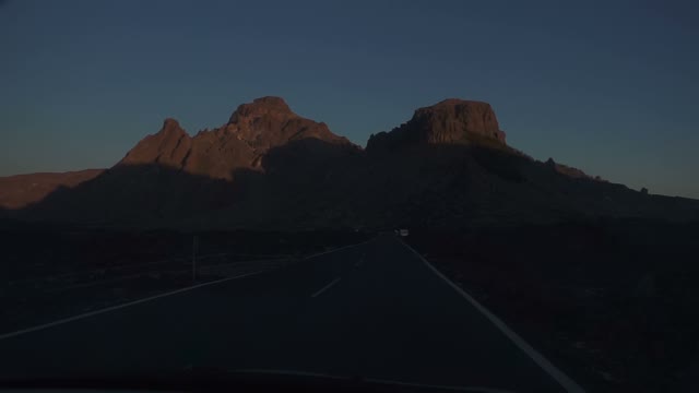 Car Moving Towards The Mountains