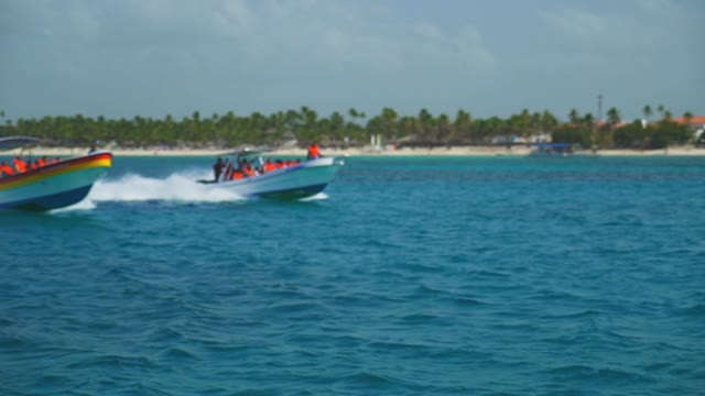 Tourists Sailing On A Speed Boat Wearing Lifejackets On Boats In The Ocean