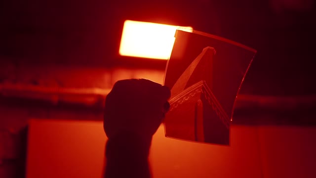 Hand Holds A Photo In The Developing Room Close-up