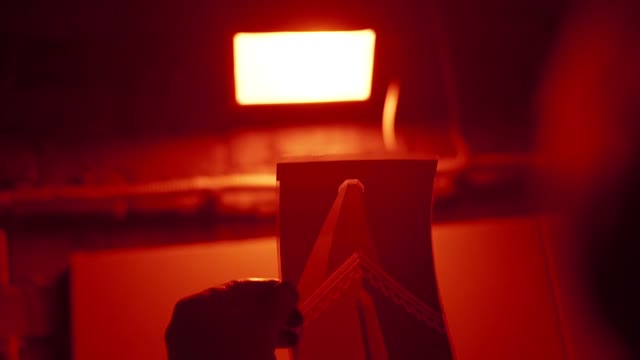 Hand Holds A Photo In The Developing Room Close-up
