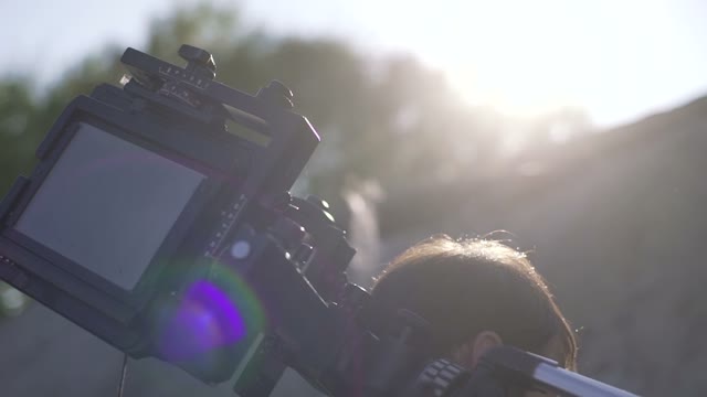 Man Puts The Retro Camera Close-up