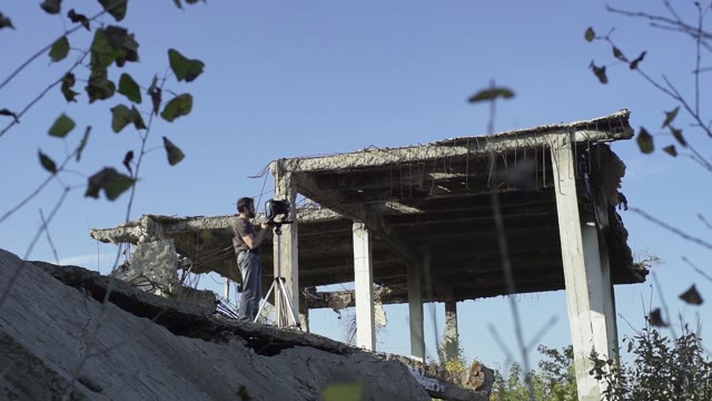 Man With A Retro Camera Among The Ruins