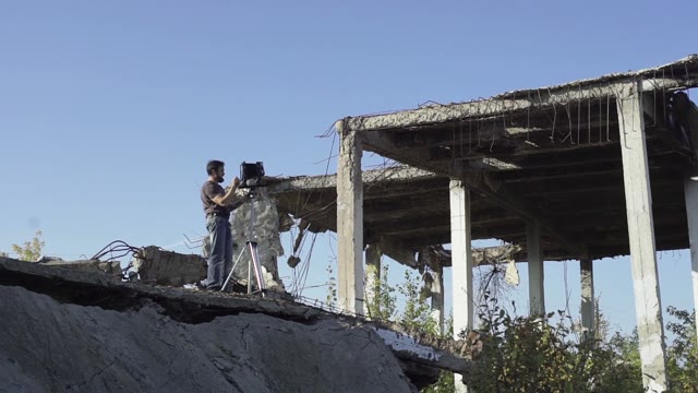 Man With A Retro Camera Among The Ruins