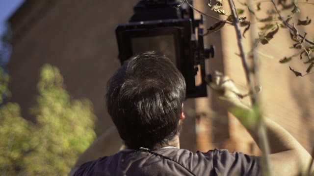 Man Photographs Chimney On The Retro Camera Close-up