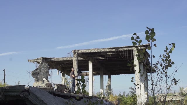 Man With Retro Camera Among The Ruins