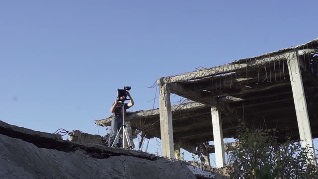 Man With Retro Camera Among The Ruins