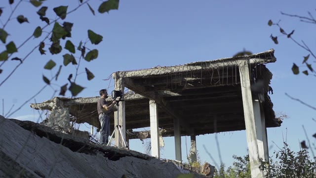 Man With Retro Camera Among The Ruins