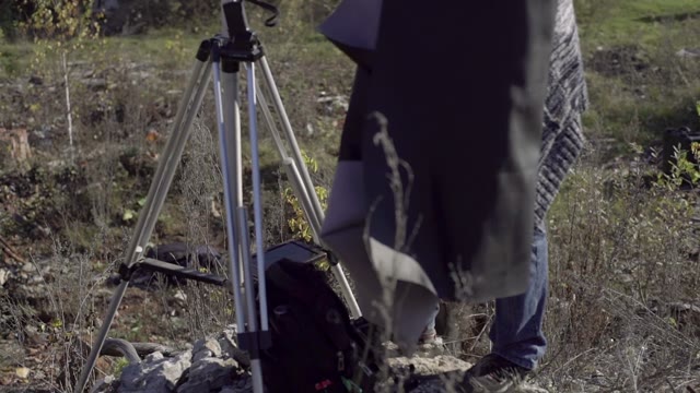 Man Photographs On Retro Camera Among The Ruins