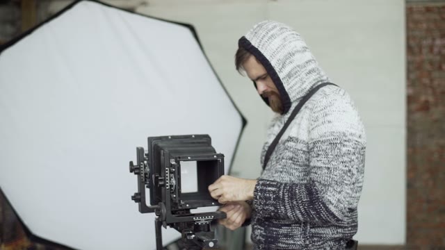 Man Demount Retro Camera In Studio Close-up