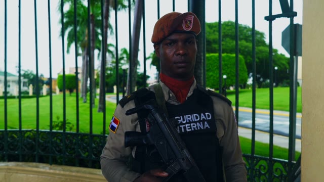 Soldier With Gun Posing In Front Of Camera