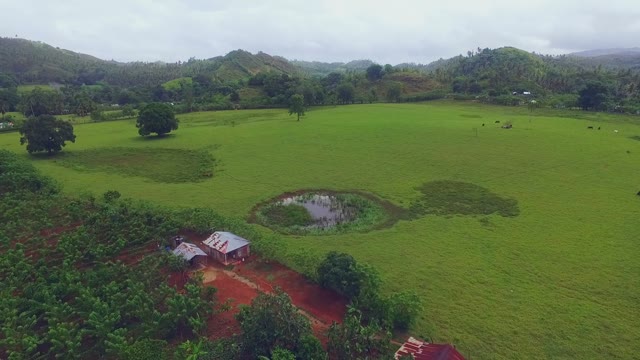 Expanses Of Green Fields And Hills On A Cloudy Day