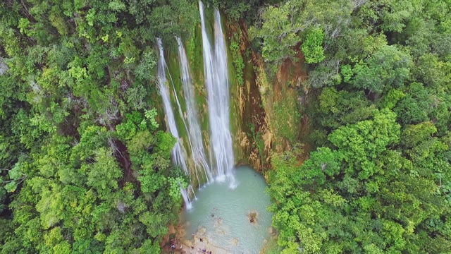A Top View Of An Incredible Waterfall And Green Tropical Trees In The Forest