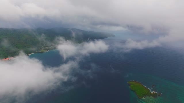 View From Quadrocopters Among The Clouds Over The Ocean And The Island With