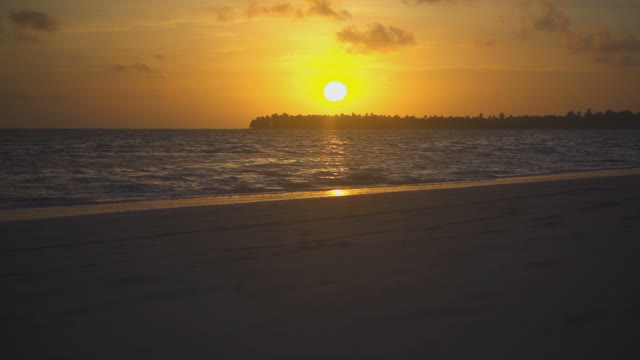 Golden Sun Near The Ocean Shore In The Calm Waves