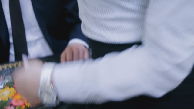 The Secretary Holds The Phone Near The Ear Of His Boss