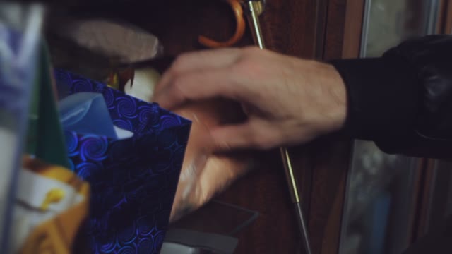 Bald Man Is Looking For Something In The Cupboard