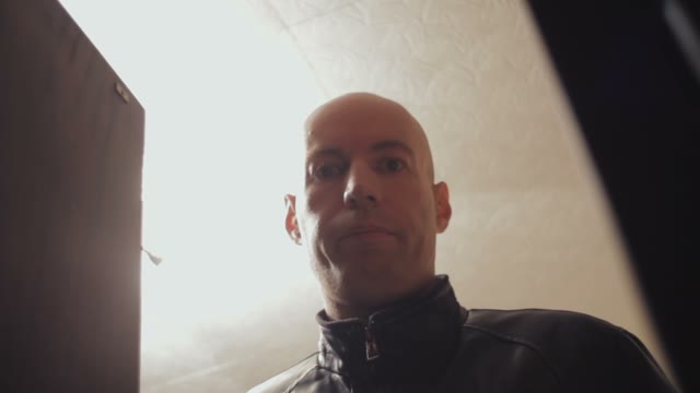 Portrait Of A Bald Man On The Background Of Illuminated Lamps