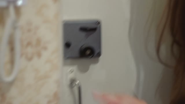 The Woman Trying To Close The Lock On The Door