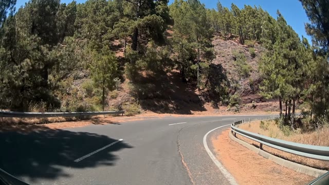 Car Is Moving Between The Stones And Green Forest Trees