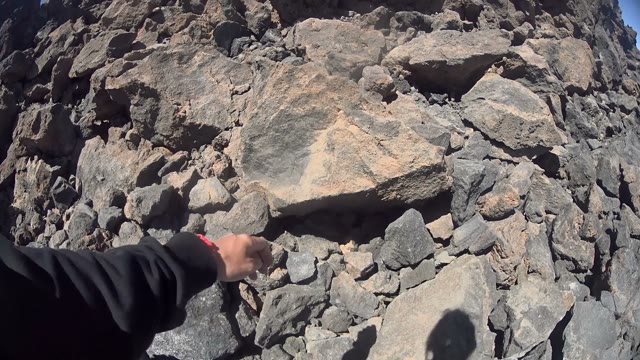 Man Filming Huge Rocks While Climbing Them