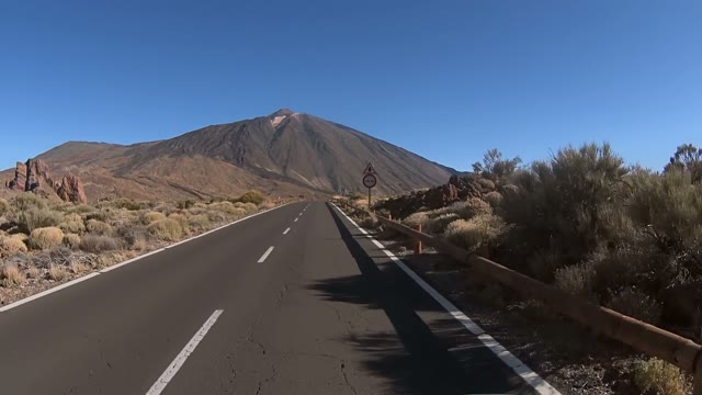 Car Is Going Up The Road To The Huge Hill