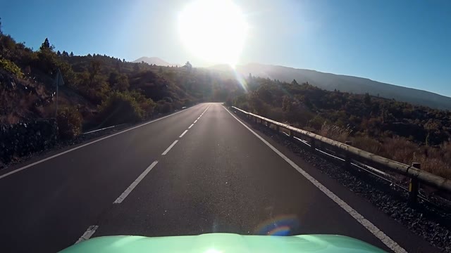 Shot Of A Car Going Down A Mountain Road
