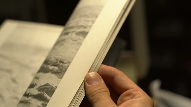Person Leafing Through A Book Close-up