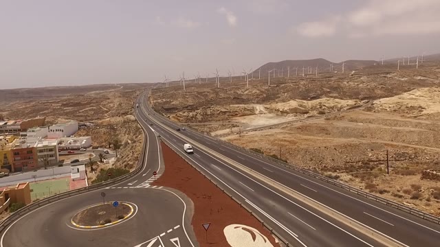 Windmills And Highway With A Huge Hill On A Background