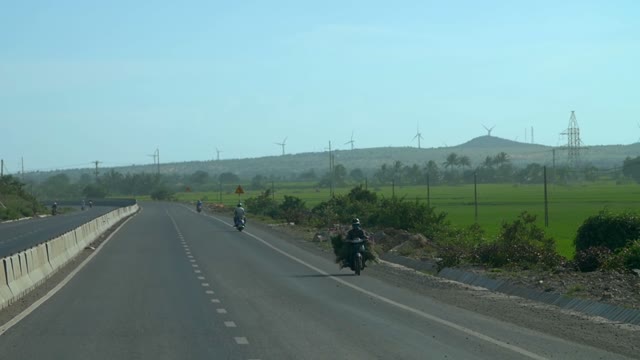 People Riding Mopeds