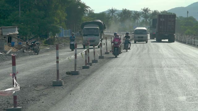 People Riding Mopeds