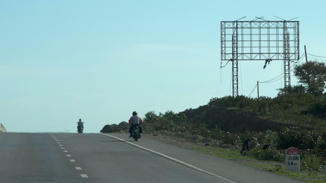 People Riding On Mopeds