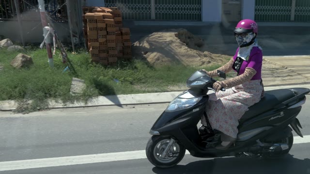 Women Riding A Moped