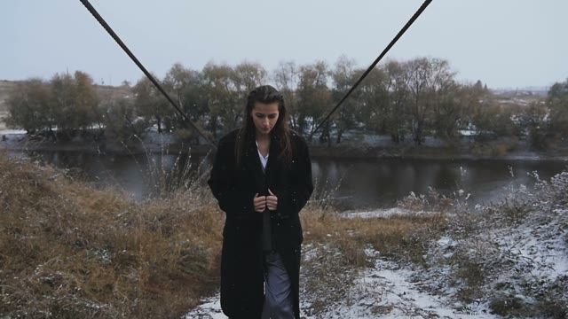 Beautiful Girl In A Suit Coat Goes By The River