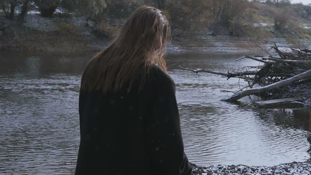 The Brunette By The River During Snowfall