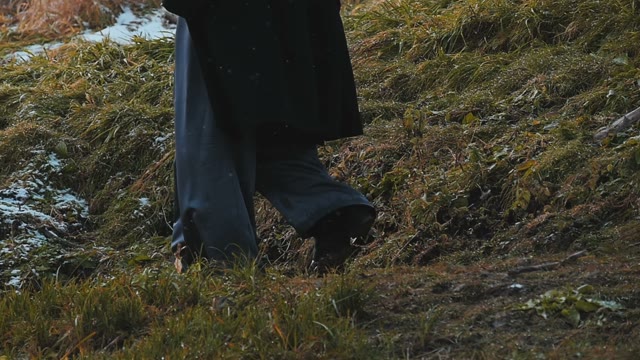 Woman Sneaks Through The Snowy Autumn Grass