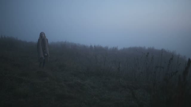 Girl In A Long Scarf Wanders Through The Fog