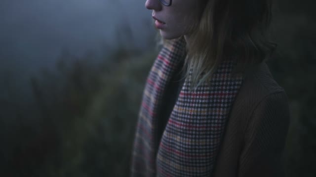 Girl In The Fog And Darkness Adjusts Her Hair