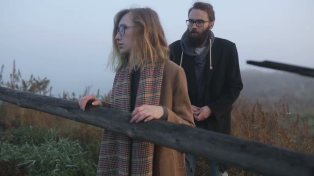A Pair Of Hipsters Cussing Outdoors