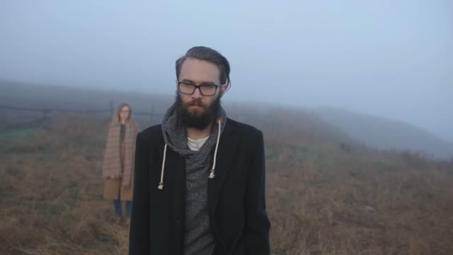 The Bearded Guy In The Foreground And A Girl Runs After Him