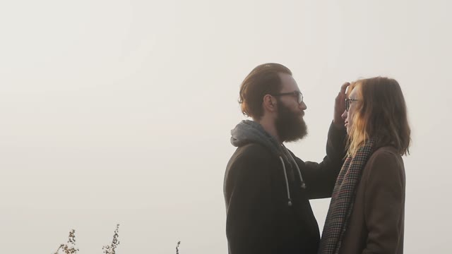 Enamored Guy Straightens The Hair His Girlfriend During The Orange Sunset