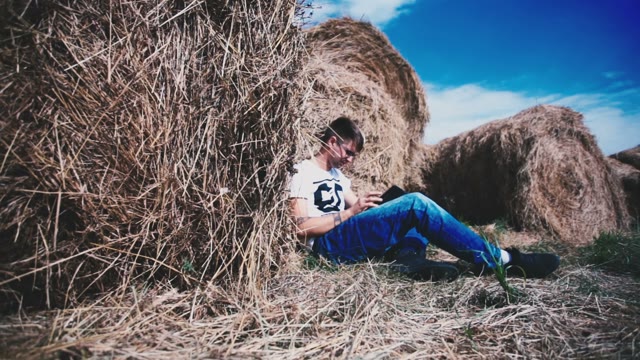 Man Among Many Haystacks Working In A Laptop