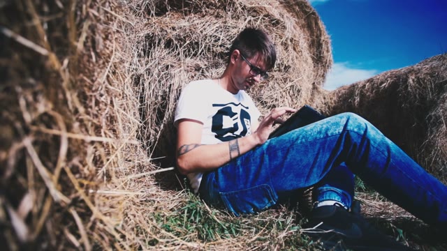 Man Working On A Laptop In A Haystack