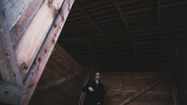 Pretty Girl Walking On The Village Barn In A Black Coat